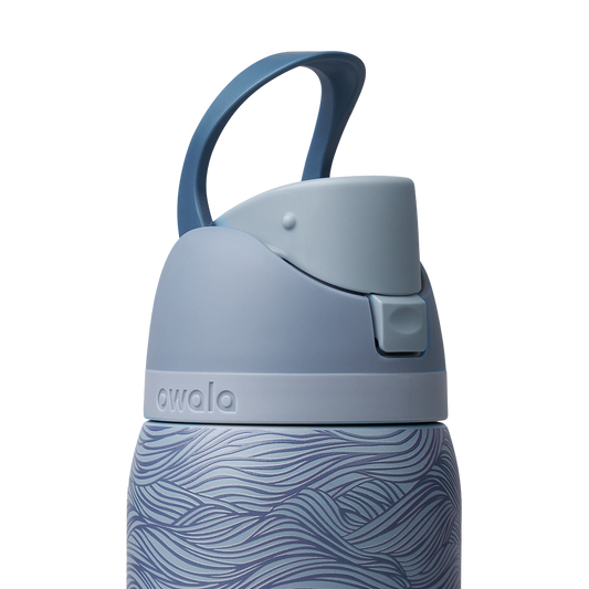 Owala FreeSip 32oz, slate blue body with embossed wave texture, lighter blue-gray lid with darker blue carry loop raised